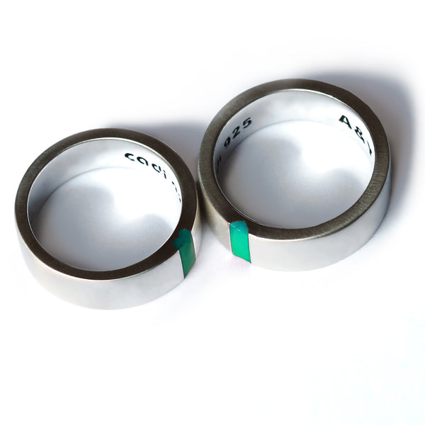 White gold or sterling silver matching rings with turquoise enamel detail revealing hidden heart design when aligned.