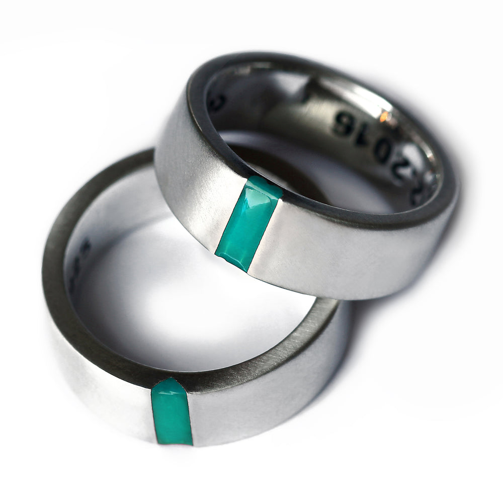 Matching silver wedding bands with turquoise enamel inlay, hidden heart negative space couple rings.
