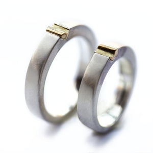 Two-tone magnetic wedding band set, brushed white gold with yellow gold connector accent, minimalist couple rings