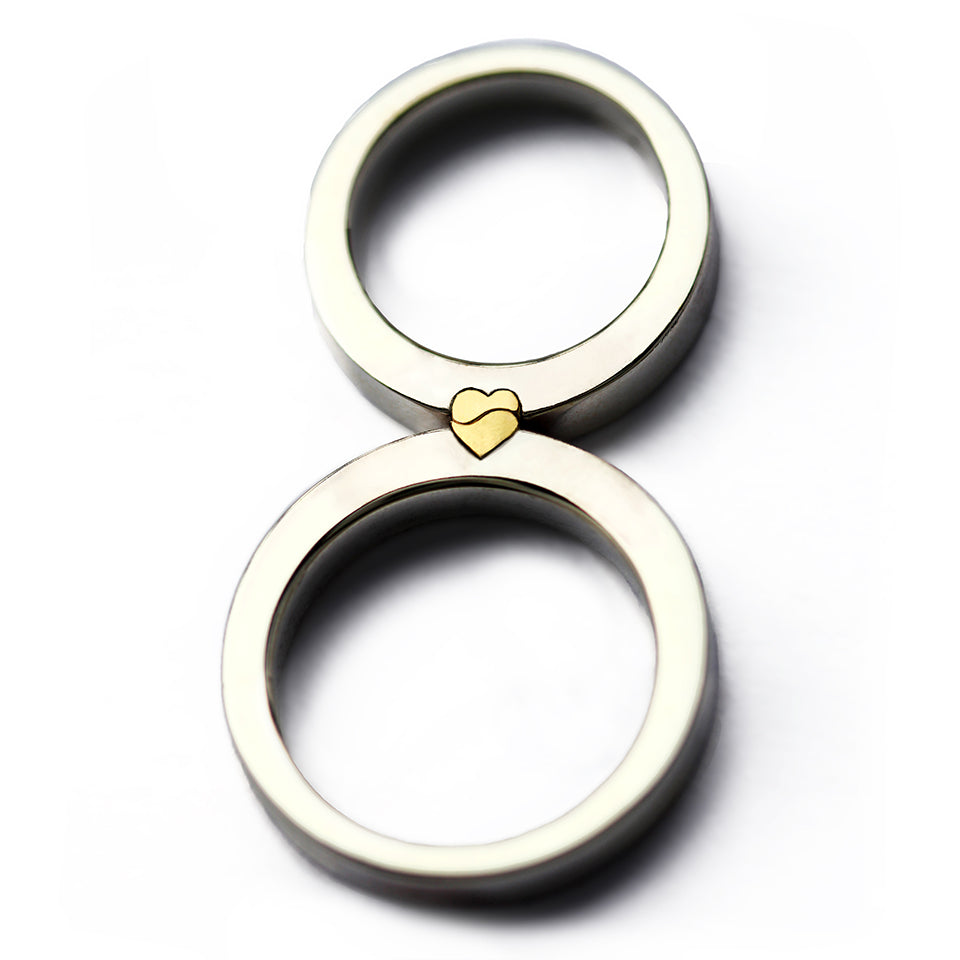 Two-piece magnetic heart ring set, white gold bands with yellow gold half-heart details, couples wedding rings