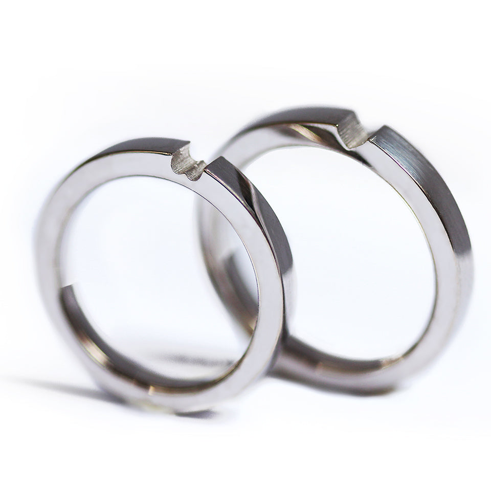 Two white gold hidden heart couple rings connected, sculptural modern matching wedding bands