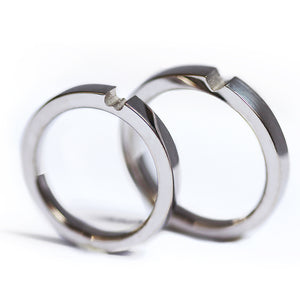 Matching white gold hidden heart rings set, modern his and hers wedding bands with sculpted connection design