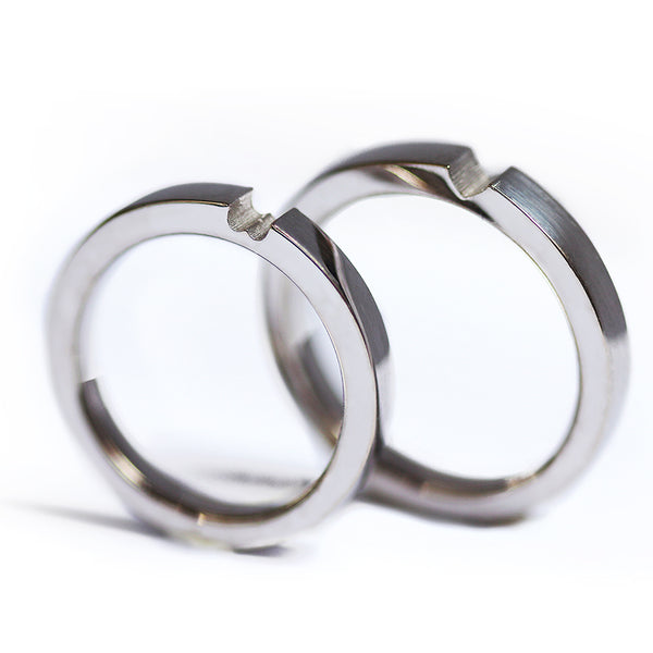 Matching white gold hidden heart rings set, modern his and hers wedding bands with sculpted connection design