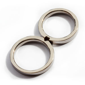 Two white gold hidden heart couple rings connected, sculptural modern matching wedding bands