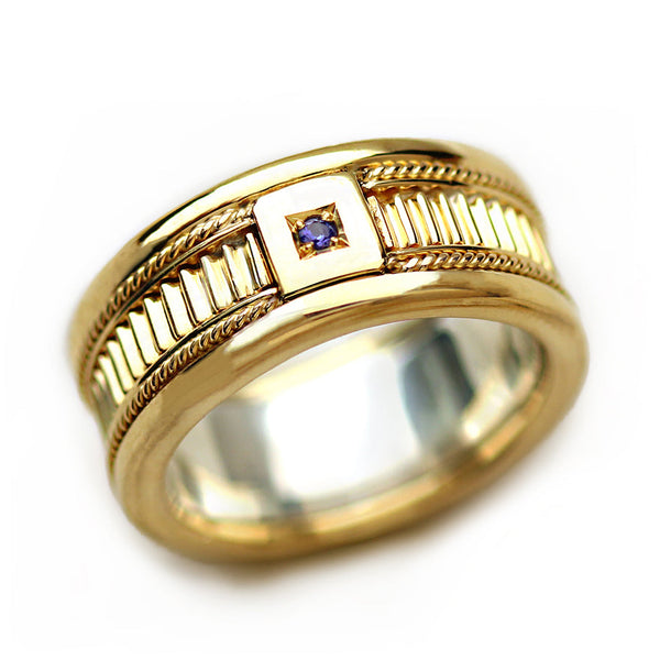 Wide men’s 18K yellow gold wedding band with square set purple sapphire center stone