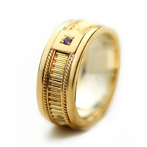 Luxury wide gold groom wedding ring with ribbed texture and purple sapphire accent