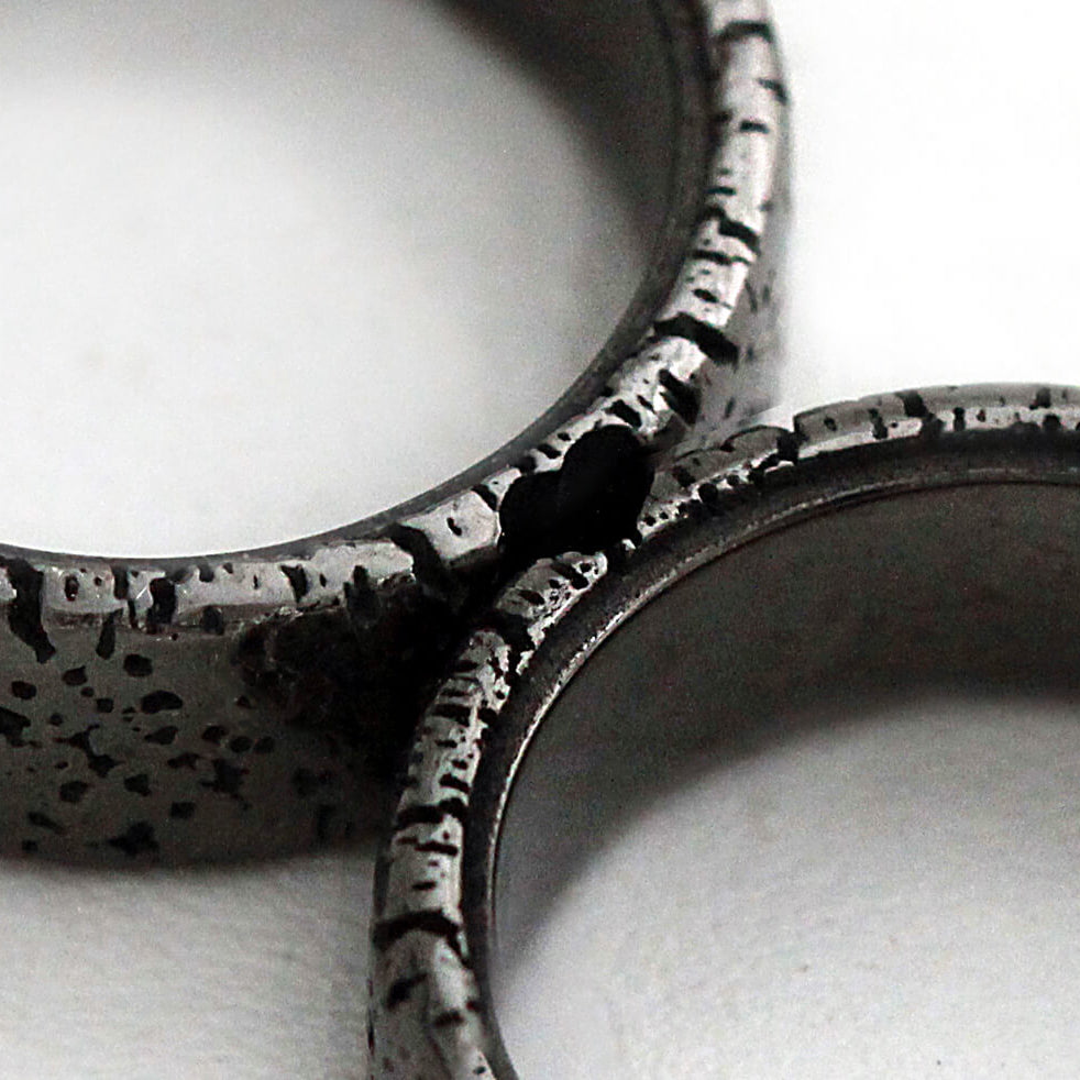 Cadi textured black rhodium wedding rings joined to reveal a hidden heart