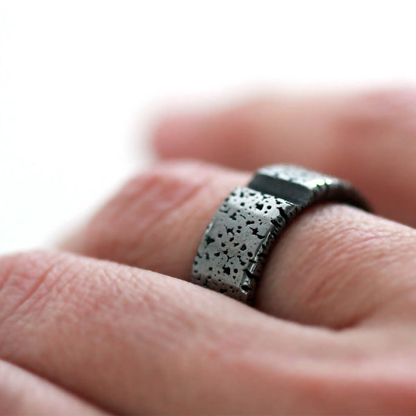 Detail of the perforated black texture and smooth inner edges of the matching bands
