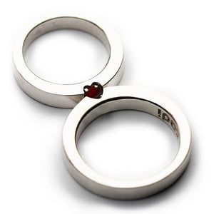 Cadi ruby and sapphire promise rings joined to form a hidden gemstone heart
