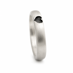 Upright view of the brushed silver promise ring showing the dark heart-shaped recess and rounded band profile