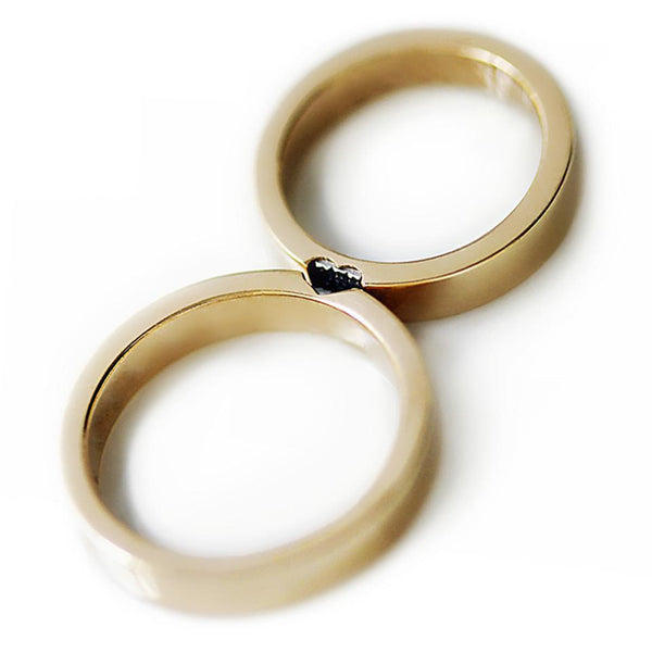 Cadi matching rings with black diamonds and natural rubies forming a hidden heart