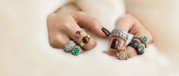 Two hands adorned with custom handcrafted rings emerging 
from water — personalized wedding bands and statement rings 
by Cadi Jewelry, crafted by master artisans in Barcelona