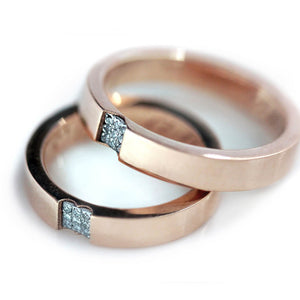 Heart-shaped Cadi couple ring set in 18k rose gold with diamond accents, each joining to symbolize a shared romantic bond.