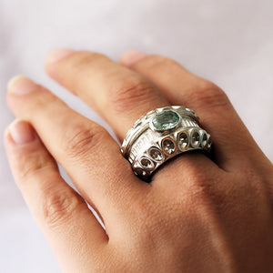 Cadi handcrafted Donut cocktail ring with a bold round aquamarine stone set in a smooth sculptural band for women.