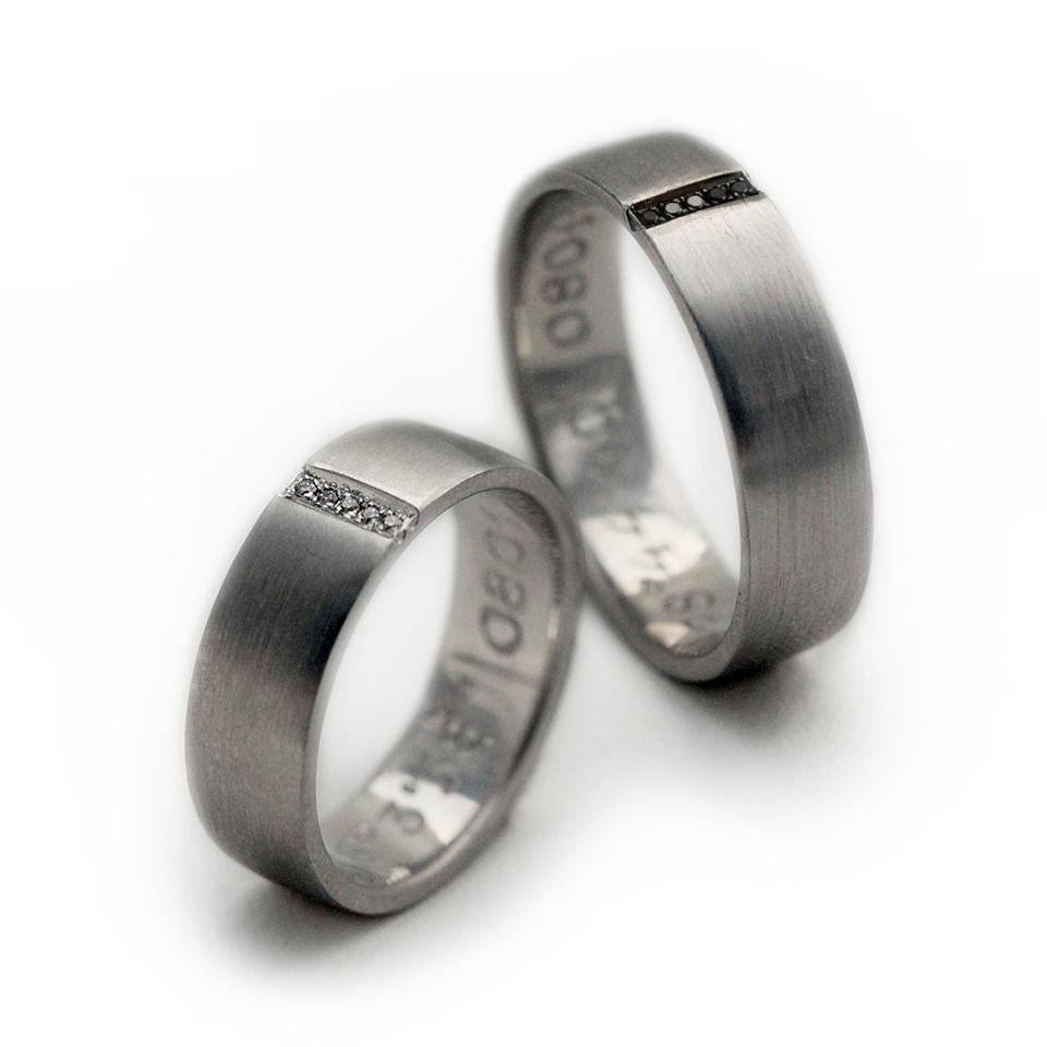 Cadi matching promise rings with black and white diamonds forming a hidden heart