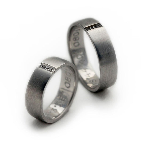 Cadi matching promise rings with black and white diamonds forming a hidden heart