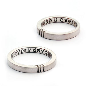 Detail of the engraved letter halves aligned between the two rings