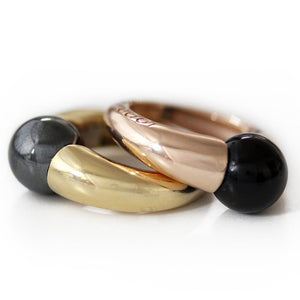 two stocking gemstone rings one in rose god versed the other one in yellow gold 