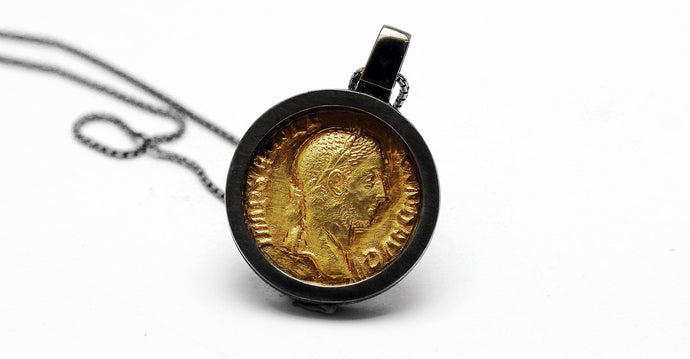 necklace with gold Roman coin and a black hoop pendent 