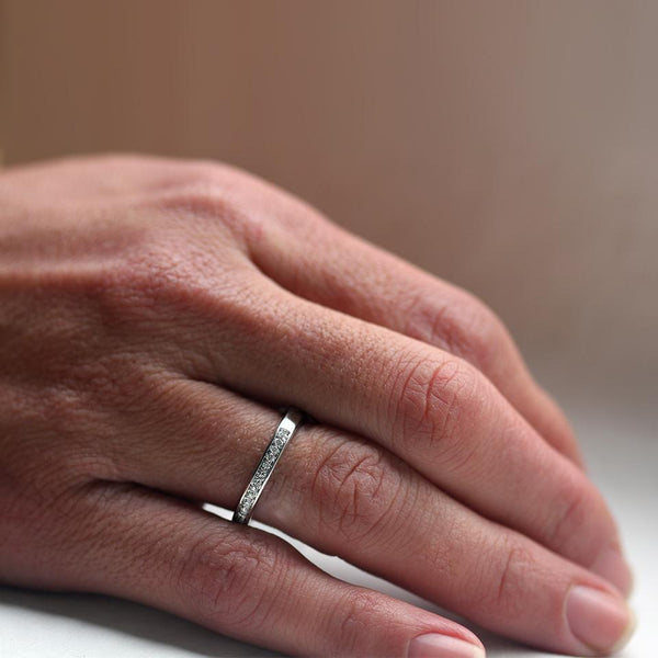 Hand wearing diamond engagement ring