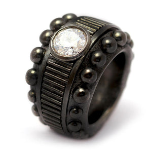 Cadi Donut cocktail ring with a bold round diamond accent, raised beads, and vertical grooves on a chunky sculptural band.