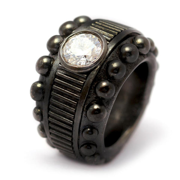 Cadi Donut cocktail ring with a bold round diamond accent, raised beads, and vertical grooves on a chunky sculptural band.