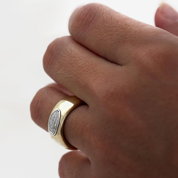 Hand wearing Armer solid gold and diamond commitment ring