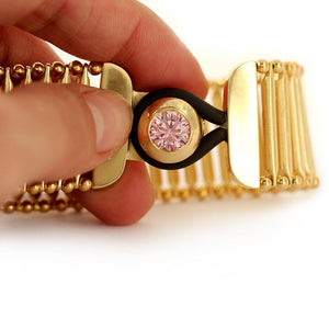 pink Cubic Zirconia gemstone in gold bracelet