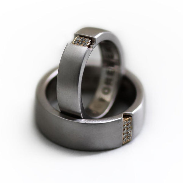 Two engraved heart rings set in silver with diamonds