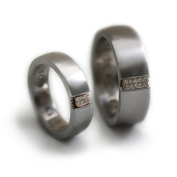 Two engraved heart rings set in silver with diamonds