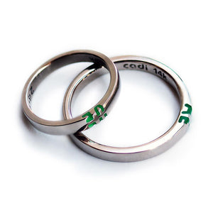 silver ring set with green initials