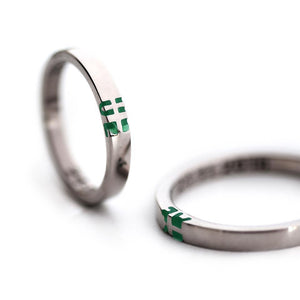 silver ring set with green initials