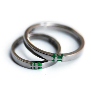 silver ring set with green initials