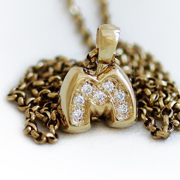 m letter personalised necklace with singular initial and round diamonds in 14k gold
