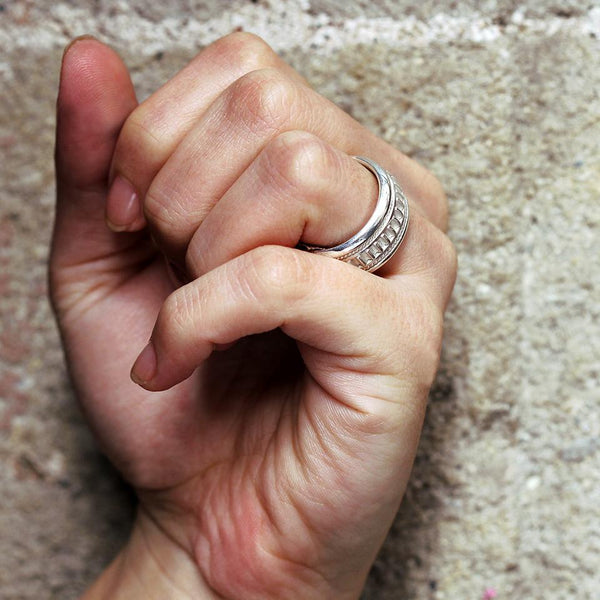 Hand wearing Coil two tone filigree texture wedding ring