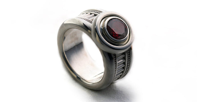 Man's silver misti wedding band with garnet