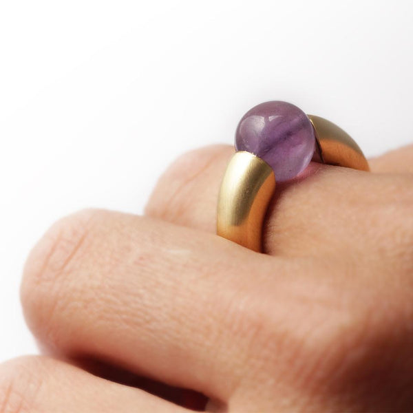 sexy unique ring on a woman's hand, a ring with purple Amethyst gemstone 