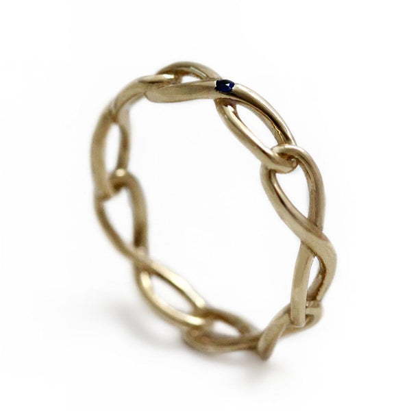 Delicate solid gold infinity shaped ring with blue Sapphire gemstone