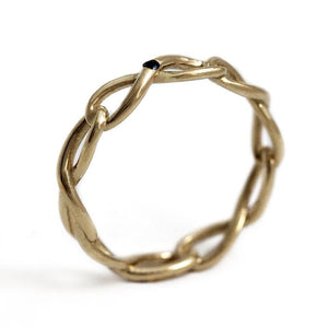Delicate solid gold infinity shaped ring with blue Sapphire gemstone