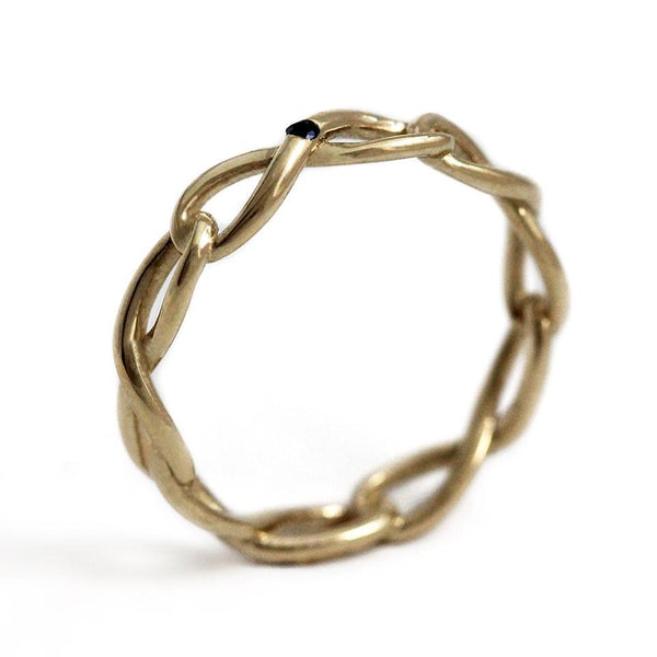 Delicate solid gold infinity shaped ring with blue Sapphire gemstone