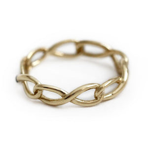 Delicate solid gold infinity shaped ring with blue Sapphire gemstone