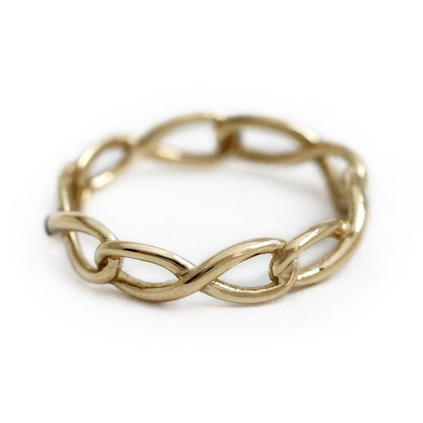 Delicate solid gold infinity shaped ring with blue Sapphire gemstone