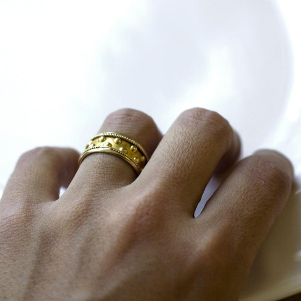 Hand wearing Gold Hills modern textured ball wedding band for women