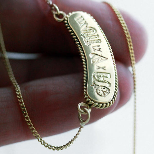 18k gold hand-fabricated design with a unique personal statement in a geometric font shape, a Name bar necklace